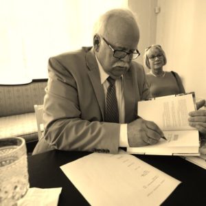 Photograph of David E. Alsobrook signing his book.