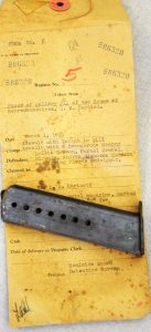 Image of ammunition magazine and evidence envelope