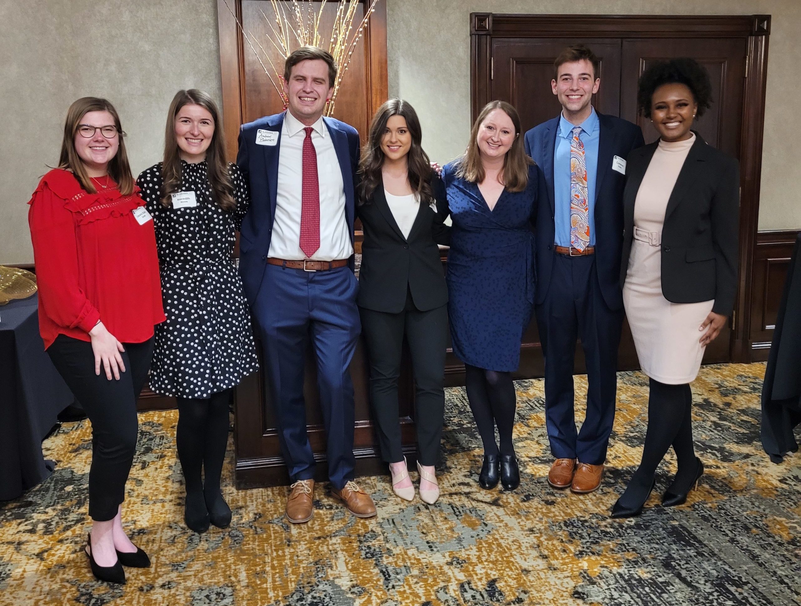 Laura Kate Smith (‘23), Meredith Moore (‘23), Andrew Blakeselee (‘22), Analeigh Barnes (‘22), Megan Walsh (‘12) Director of DC Externships, Cameron Dobbs (‘23), and Amani Moore (‘23) pose for a photo at the Dean’s Reception at the City Club on March 1, 2022